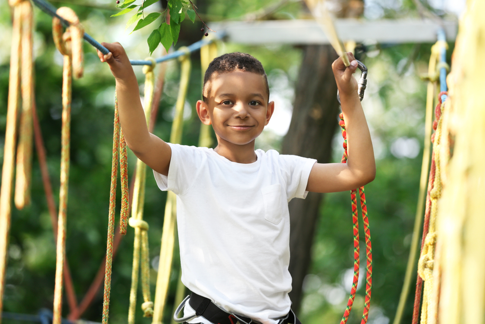 little boy climbing needs summer camp gear