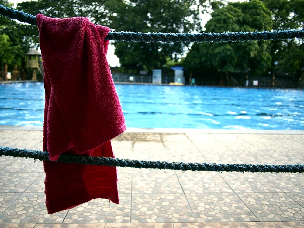 Red Custom Towel Hanging by Swimming Pool