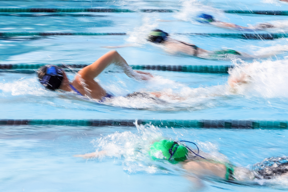 high school students swimming in pool