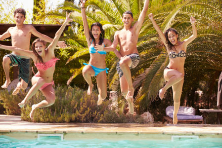 kids jumping into pool