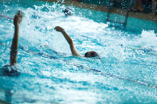 swim team swimming in pool