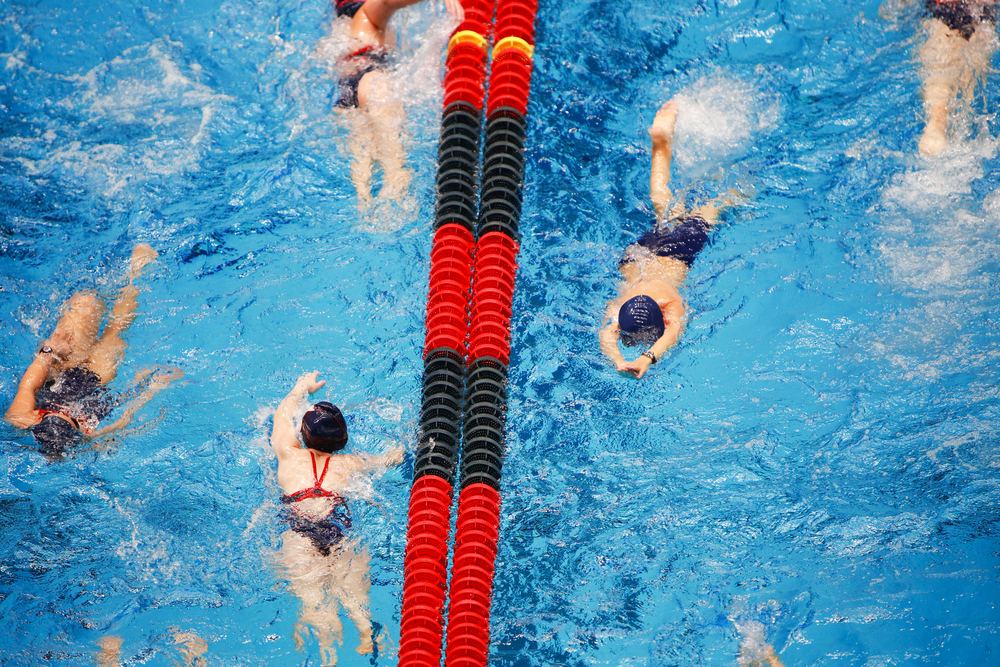 Young Swim team warming up in the pool, some motion blur on swimmers