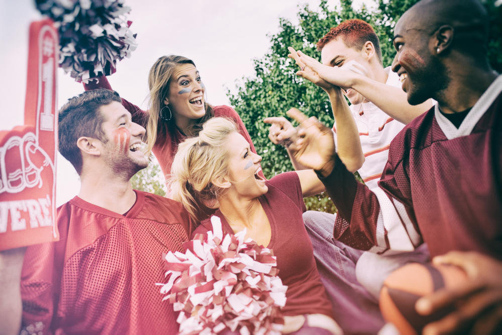 Tailgating: College Student Fans Give High Five For Team Win